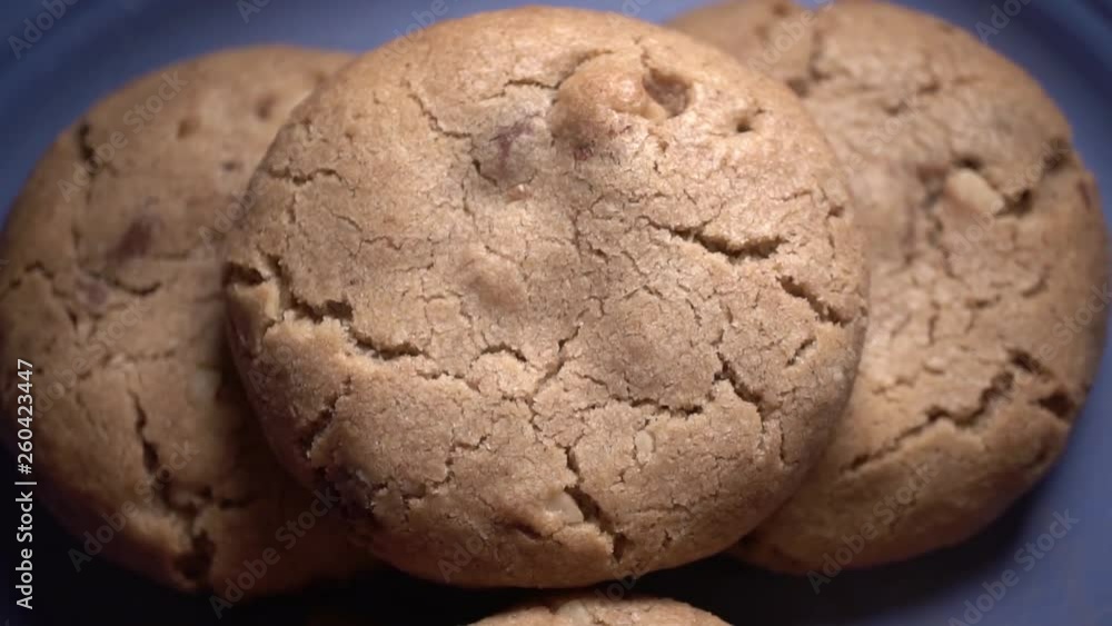 Fresh baked walnut chocolate chip cookies on blue plate, Macro Close Up Gib Shot Fresh baked walnut chocolate chip cookies on blue plate, Macro Close Up Gib Shot