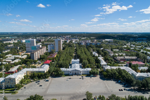 Top down aerial drone image of a Ekaterinburg city and house of culture with square in the midst of summer, backyard turf grass and trees lush green.