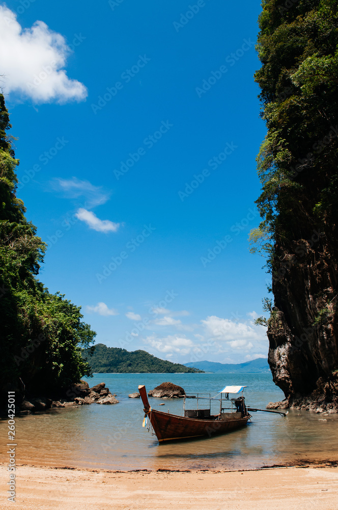 Kayak and Thai wooden longtail boat on the beach, Krabi - Thailand
