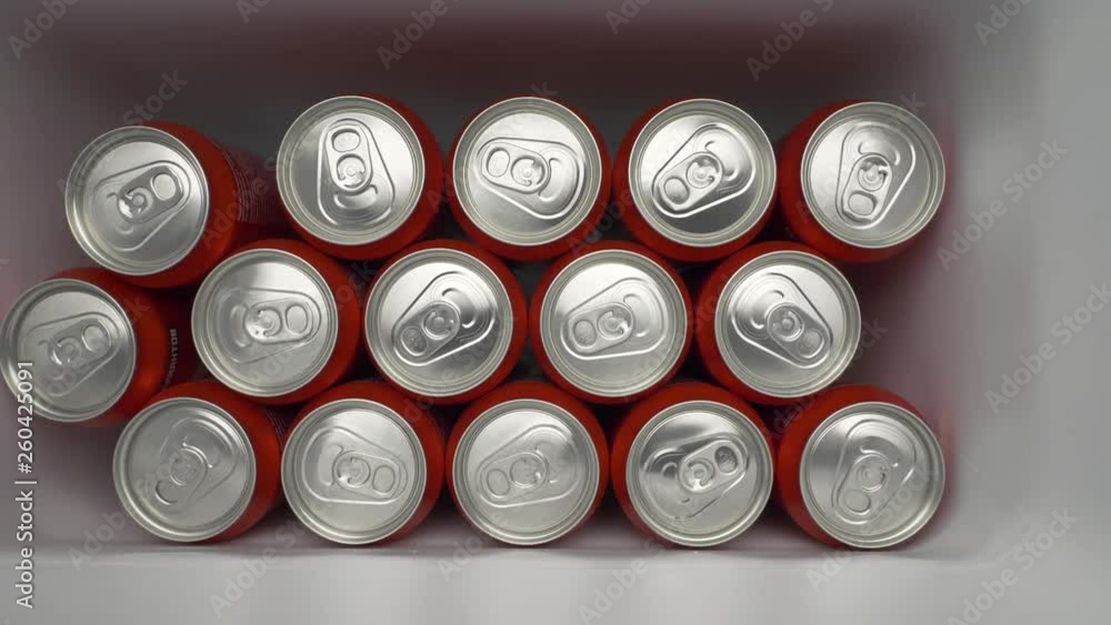 refrigerator clogged with cans of soda. aluminum cans of beverage lie in an filled fridge. Cans with beer on a shelf in the refrigerator. dolly slow motion shot close up medium refrigerator clogged with cans of soda. aluminum cans of beverage lie in an filled fridge. Cans with beer on a shelf in the refrigerator. dolly slow motion shot close up medium