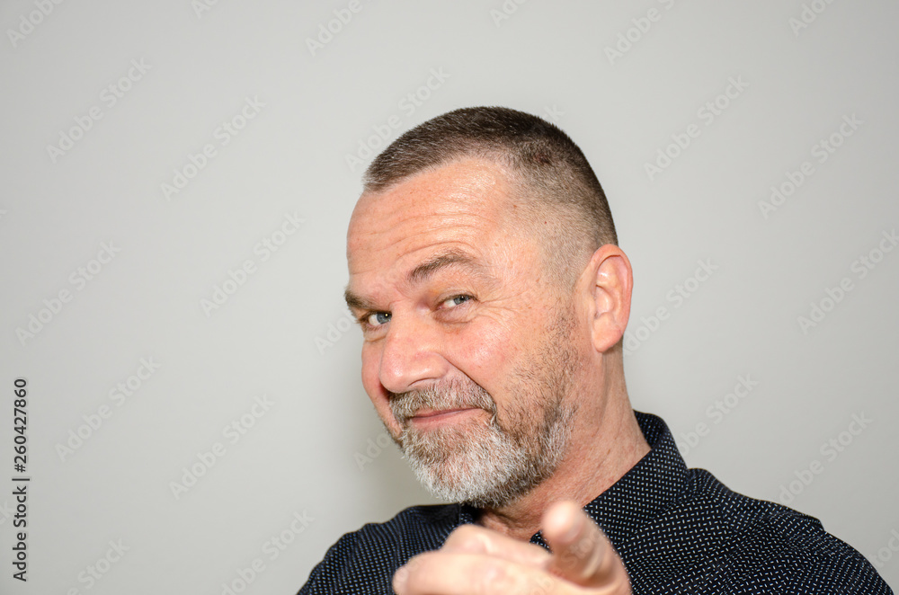 Charismatic middle-aged man pointing a finger Charismatic middle-aged man pointing a finger