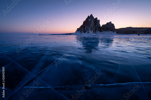 Shaman rock, sacred stone in Olkhon island in a beautiful morning sunrise, Baikal lake in winter, Russia photo