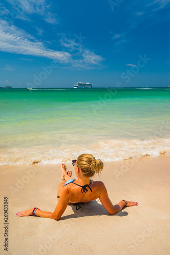Woman enjoying her holidays on the tropical beach i