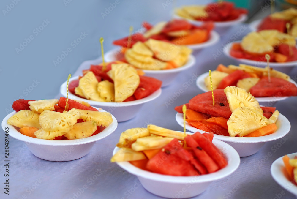 Close-up view of Indian street food Fruit salad in a plate,isolated on white background Close-up view of Indian street food Fruit salad in a plate,isolated on white background