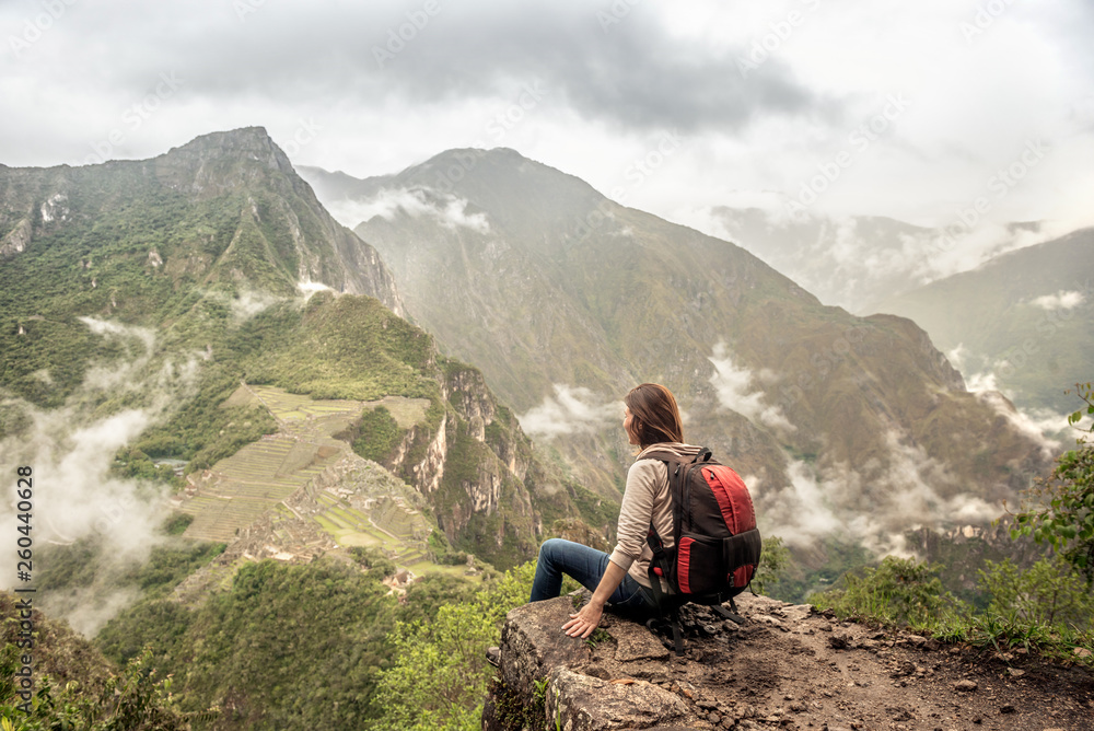 Fototapeta premium Girl-hiker looking on top of Huayna Picchu, looking on Machu Picchu