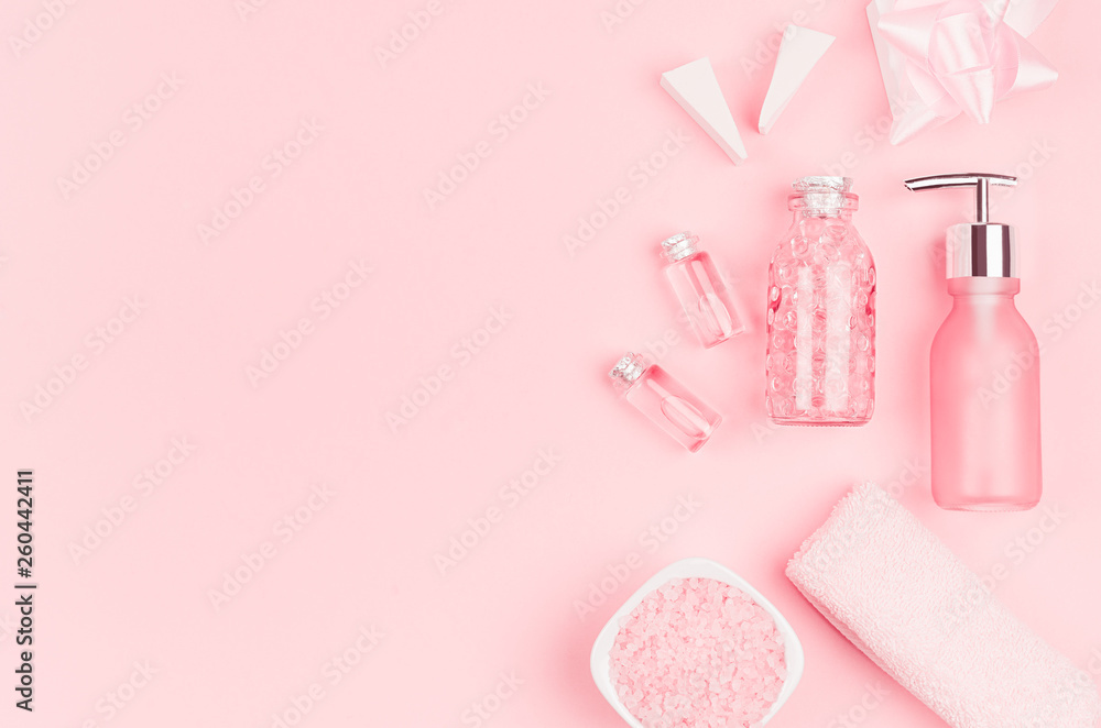 Spring fresh cosmetic products for makeup and bath in pastel pink color as decorative border, top view. Spring fresh cosmetic products for makeup and bath in pastel pink color as decorative border, top view.