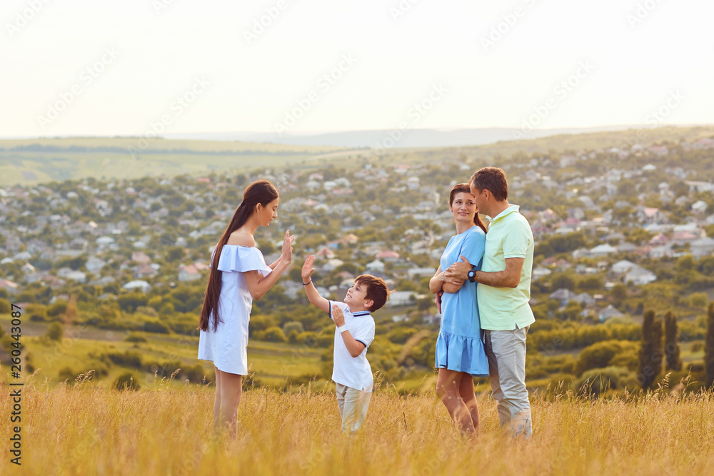 Happy family playing fun on the field at sunset. Happy family playing fun on the field at sunset.