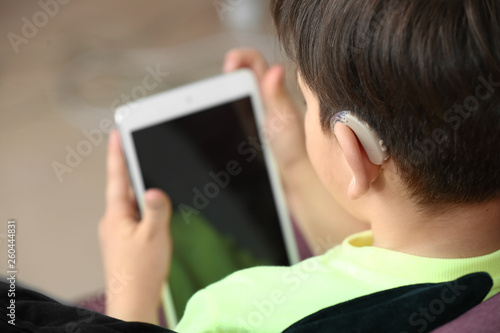 Little boy with hearing aid...