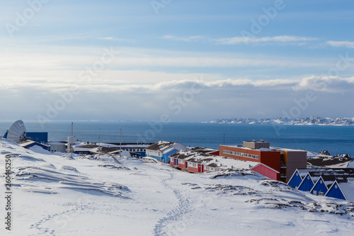 Inuit village houses covered in snow at the fjord of Nuuk city, Greenland © vadim.nefedov