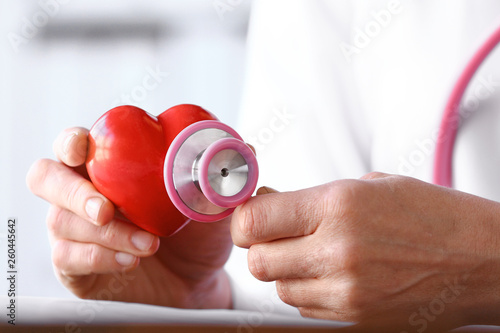 Female doctor with stethoscope and heart, closeup