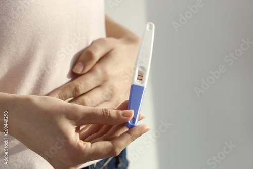 Woman with pregnancy test  closeup