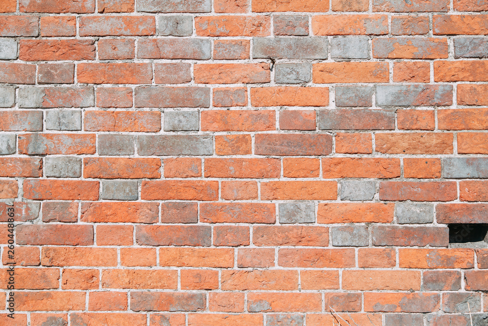 Fototapeta premium Textured wall of the old house. Texture of old brick wall with paint.