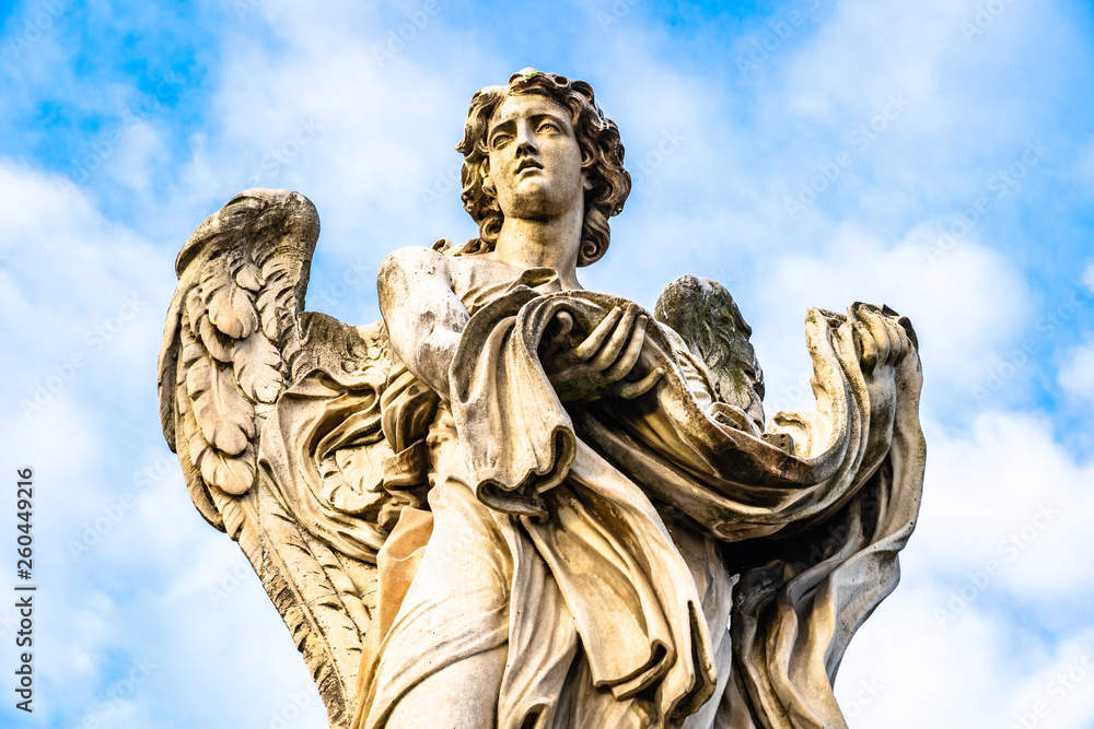 Statue of an Angel with the Garment and Dice by Paolo Naldini on Sant'Angelo brigde in Rome, Italy
