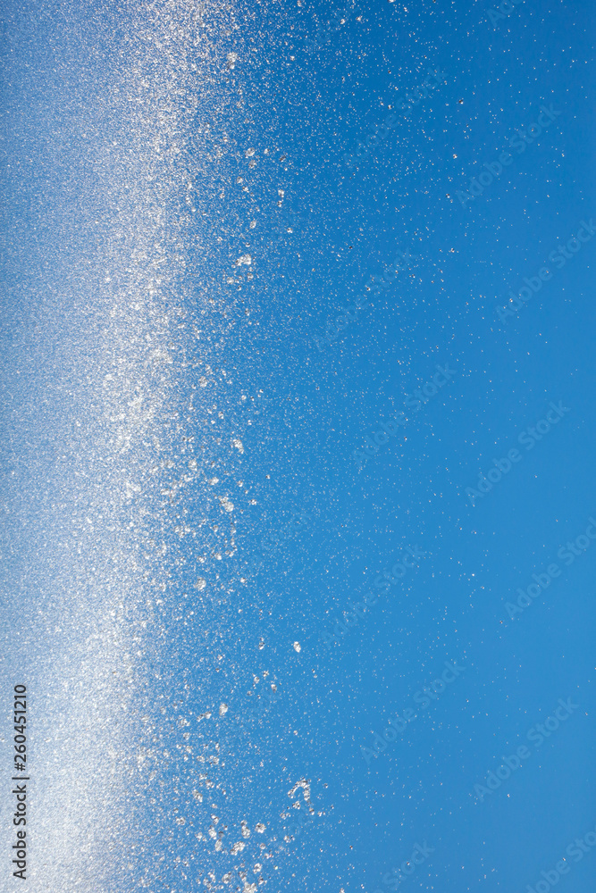 Splashes of water against the blue sky Splashes of water against the blue sky