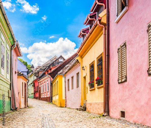 Old medieval cobblestone stree with colorful houses in Sighisoara, Transylvania, Romania © PhotoFires