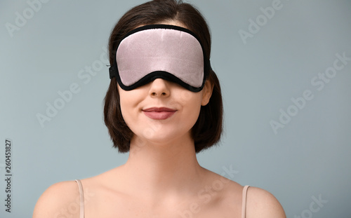 Young woman with sleep mask...