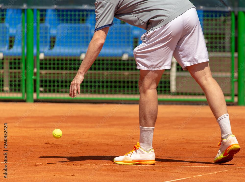 A man plays tennis on the court in the park