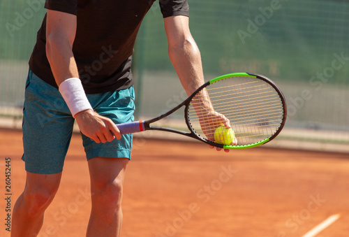 A man plays tennis on the court in the park