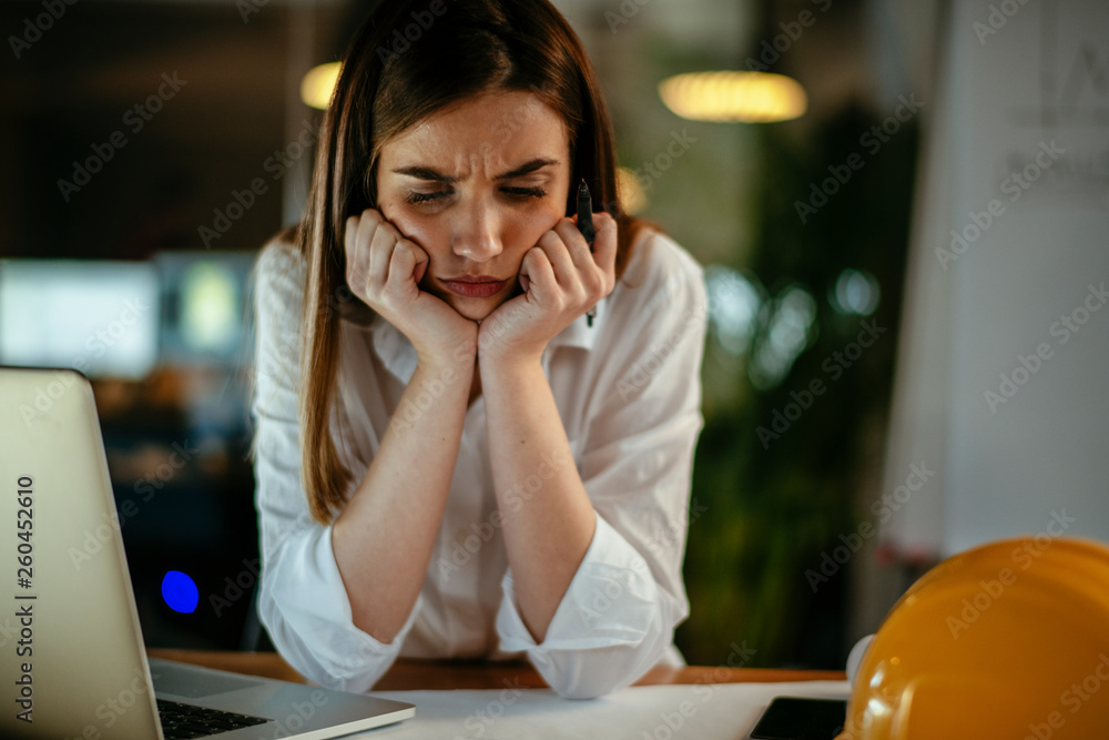 Young woman architect working on a project. Female engineer at her desk. Young woman architect working on a project. Female engineer at her desk.