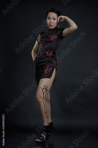 Asian woman with fake drawing tattoo on her leg photo