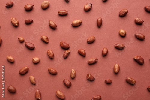 Tasty peanuts on color background