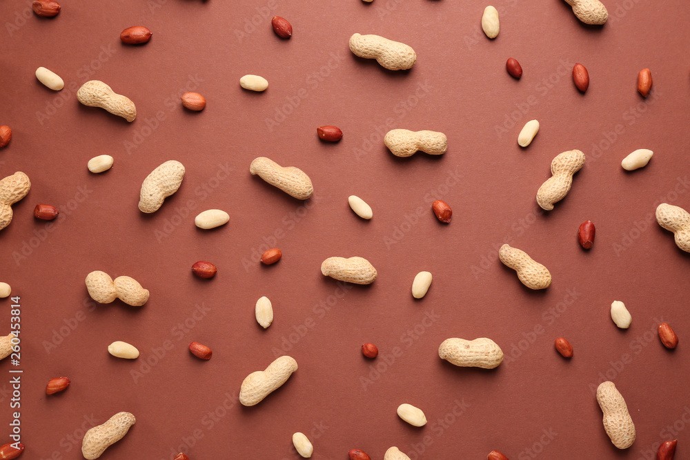 Fototapeta premium Tasty peanuts on color background