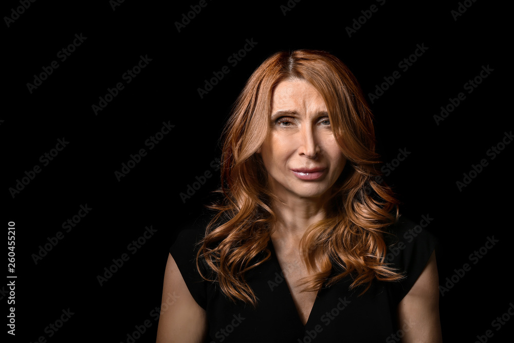 Fototapeta premium Mature woman on dark background