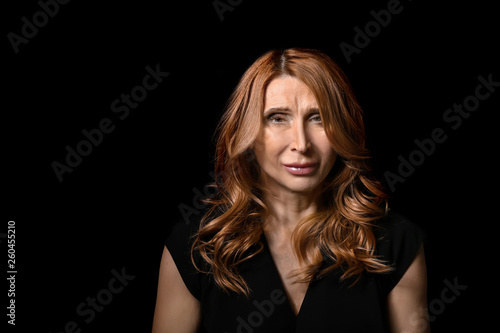 Mature woman on dark background