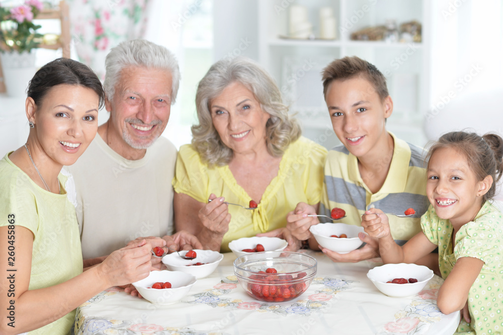Portrait of big happy family eating fresh strawberries Portrait of big happy family eating fresh strawberries