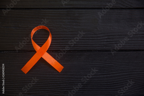 Orange ribbon symbol of leukemia, cancer awareness month.