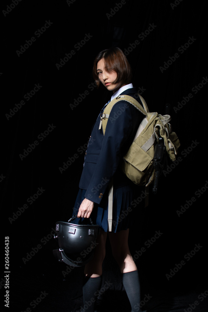 Asian Chinese girl dressed in school uniform cosplay PUBG character wearing school uniform, an iron halmet, and M16 toy gun. Asian Chinese girl dressed in school uniform cosplay PUBG character wearing school uniform, an iron halmet, and M16 toy gun.