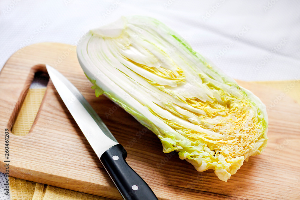Half of Chinese cabbage on wooden cutting board
