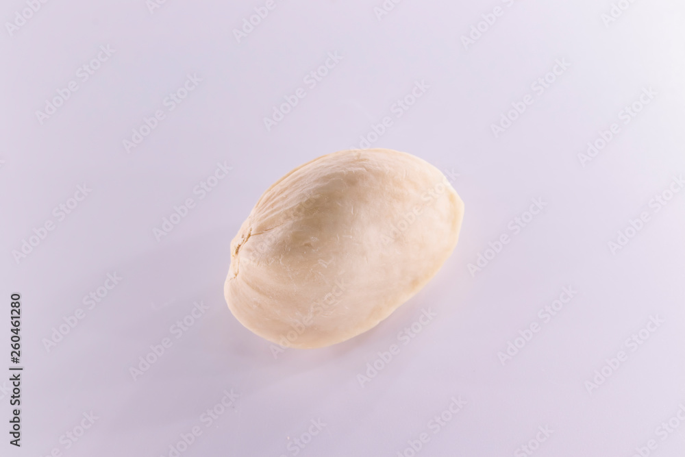 Peeled and unpeeled pistachio nuts isolated on white background