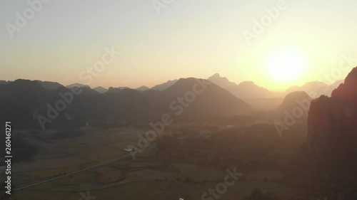 Wallpaper Mural Aerial: Vang Vieng backpacker travel destination in Laos, Asia. Sunset scenic cliffs rock pinnacles rice paddies valley stunning landscape. Native cinelike D-log color profile Torontodigital.ca
