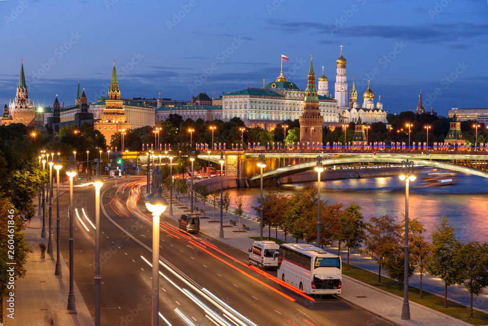 Evening view of Moscow street. Embankment of Moscow river. Traces of car headlights moving cars.	