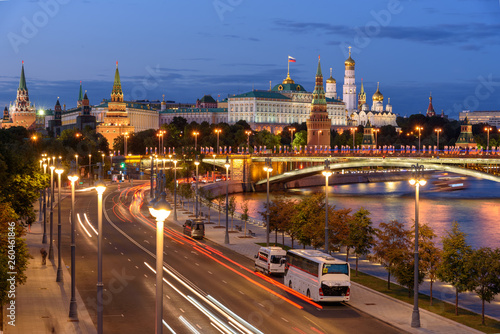 Evening view of Moscow street. Embankment of Moscow river. Traces of car headlights moving cars. 