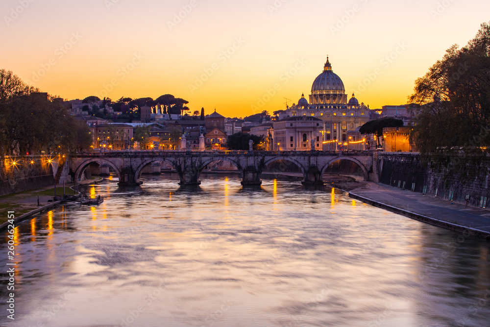 Twilight view of St. Peter's Basilica with Tiber River in Rome, Italy