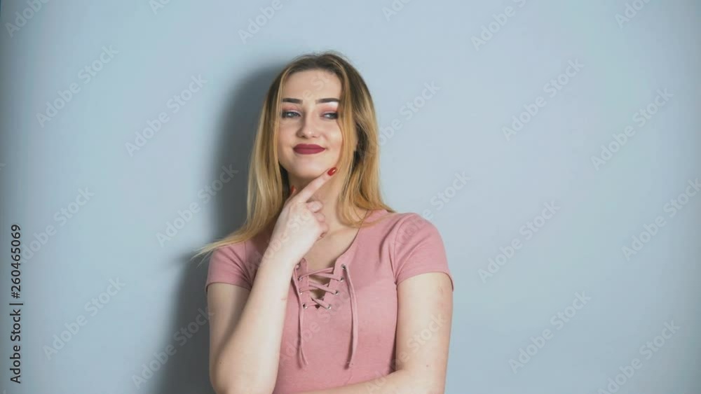 beautiful young girl confidently looking into the camera and flirting on a studio background, concept of female behavior and emotions beautiful young girl confidently looking into the camera and flirting on a studio background, concept of female behavior and emotions