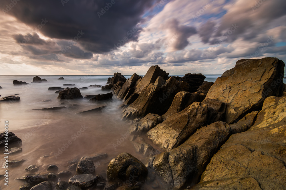 Flysch rocks in barrika beach at the sunset