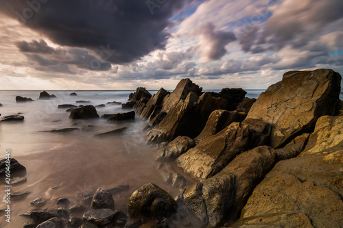 Flysch rocks in barrika beach at the sunset