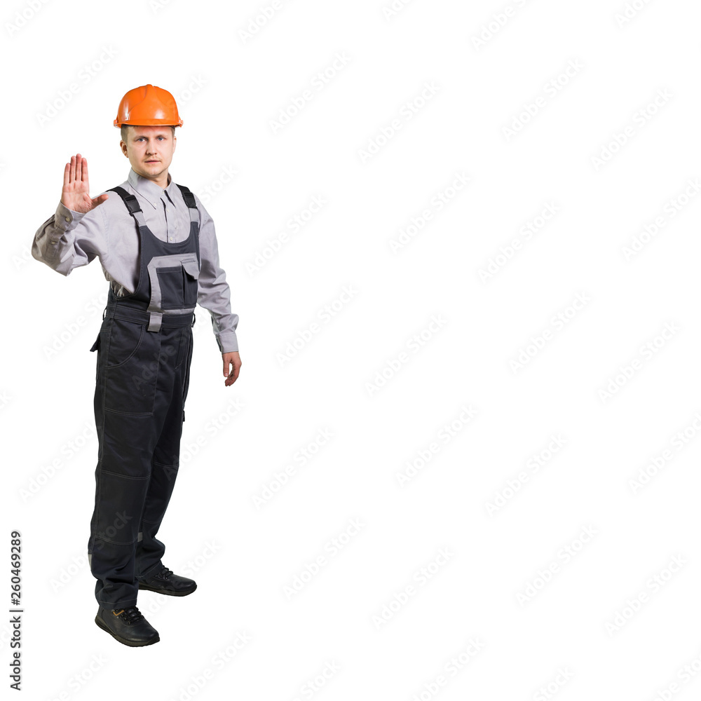 Engineer builder in a helmet, shows a prohibitive sign of the palm. isolated Engineer builder in a helmet, shows a prohibitive sign of the palm. isolated