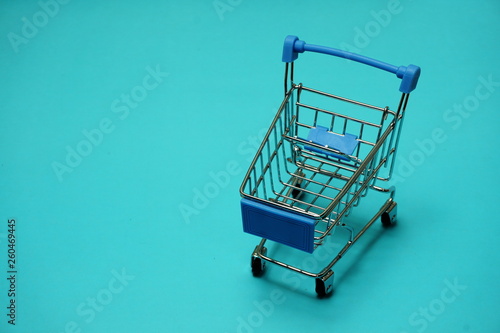 Mini trolley cart on blue background