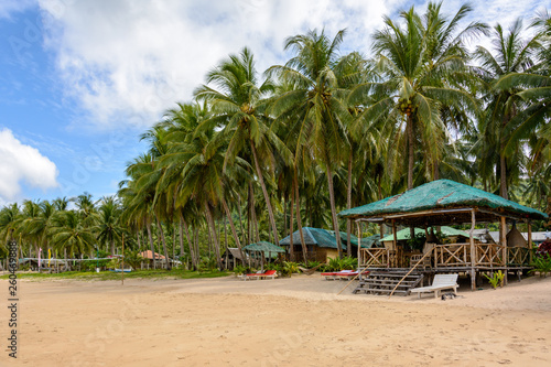 El Nido Beach, Philippines - wooden lounge area on a sandy beach