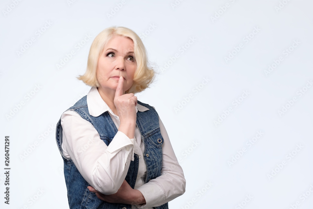 senior woman smirking thinking trying create plan in mind senior woman smirking thinking trying create plan in mind
