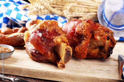 Traditional German cuisine, Schweinshaxe roasted ham hock and pretzels photo