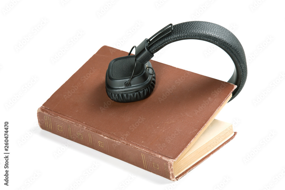 modern headphones on an old book. White background modern headphones on an old book. White background