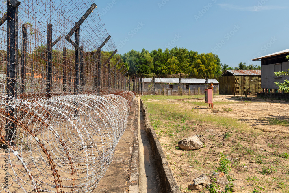 Rollers of razor barbed wire and elctrical fence around Phu Quoc Prison, Vietnam.