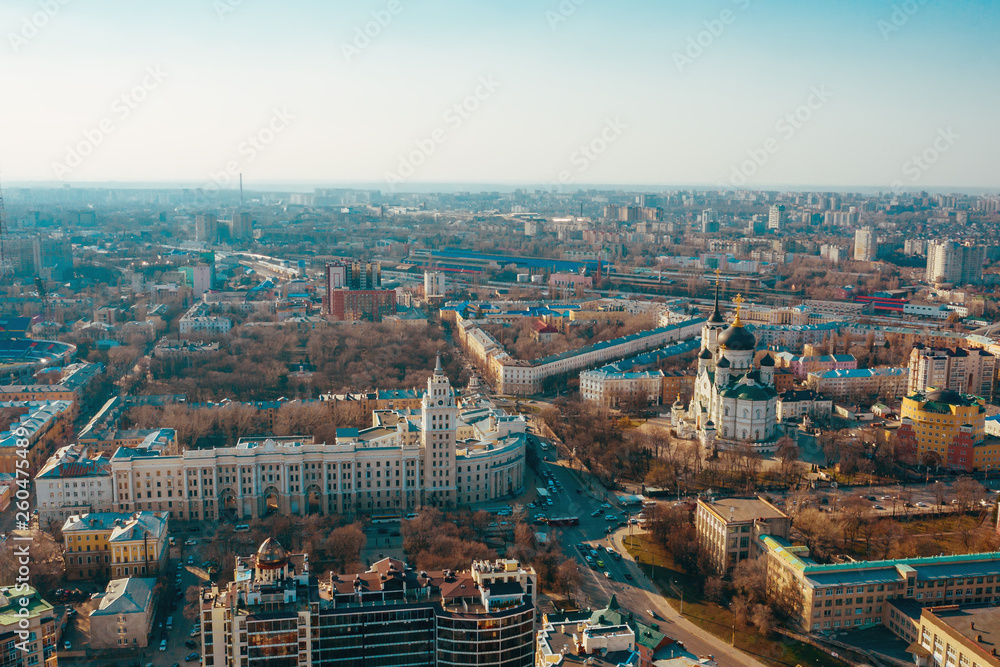 Aerial Voronezh panorama of city midtown in spring evening, roads with traffic cars, famous Orthodox cathedral church and South-Eastern Railway Building