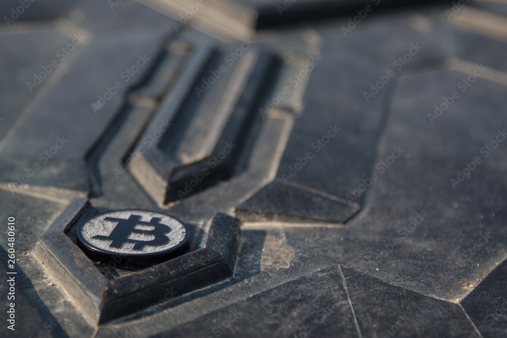 Made from black plastic custom bit coin on rustic old background Made from black plastic custom bit coin on rustic old background