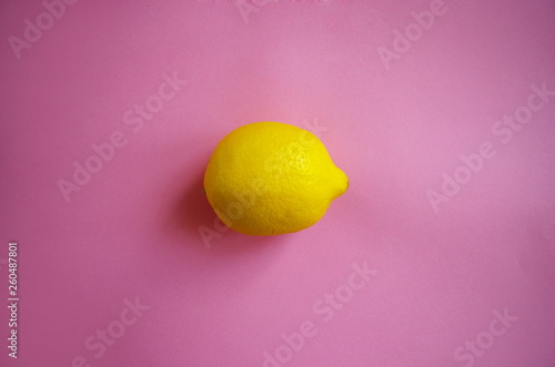 Lemon on pink background, trendy healthy lifestyle background